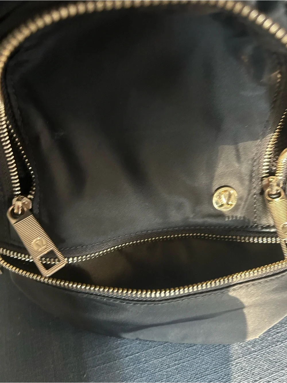 Lululemon City Adventurer Backpack Micro 3L in Black with Gold hardware.